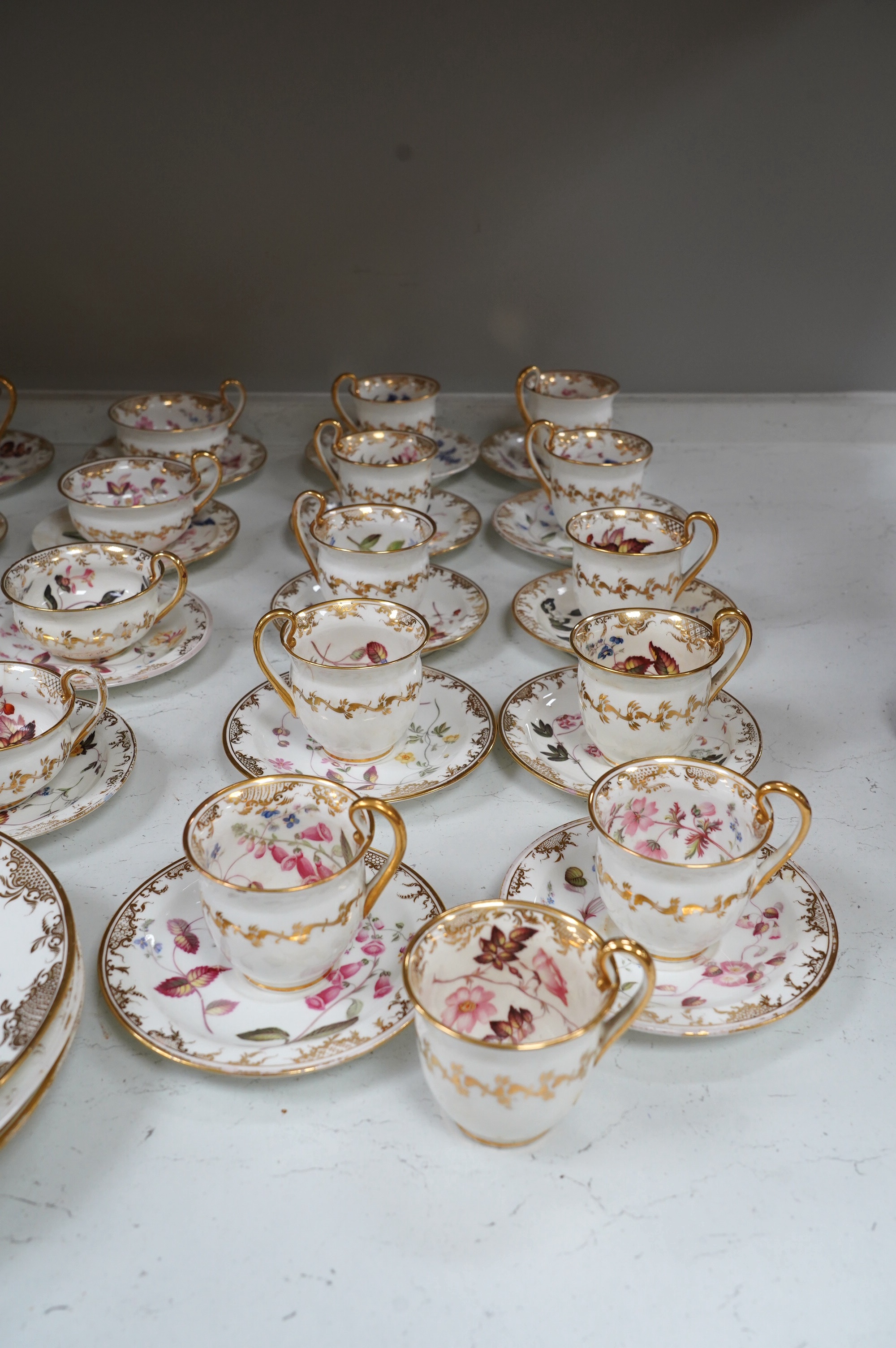 A floral part tea and coffee set, probably Swansea, c.1815-20, largest 23.5cm diameter. Condition - mostly fair